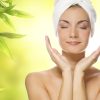 Beautiful young woman applying organic cosmetics to her skin